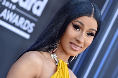 Cardi B posing with jewelry on a red carpet