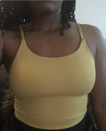 Reviewer in yellow cropped tank top 