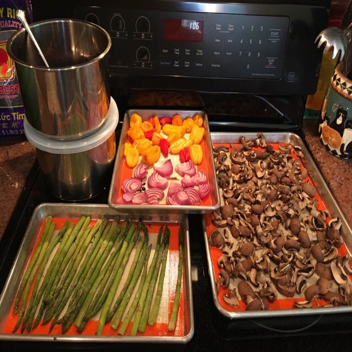 Reviewer uses same baking mat set to heat up asparagus and various veggies in their oven