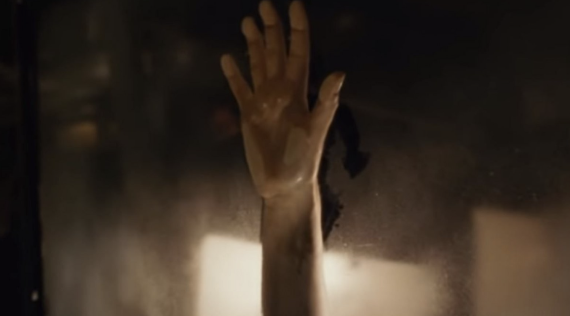 Rose's hand making an imprint against the steaming car window while she and Jack make love