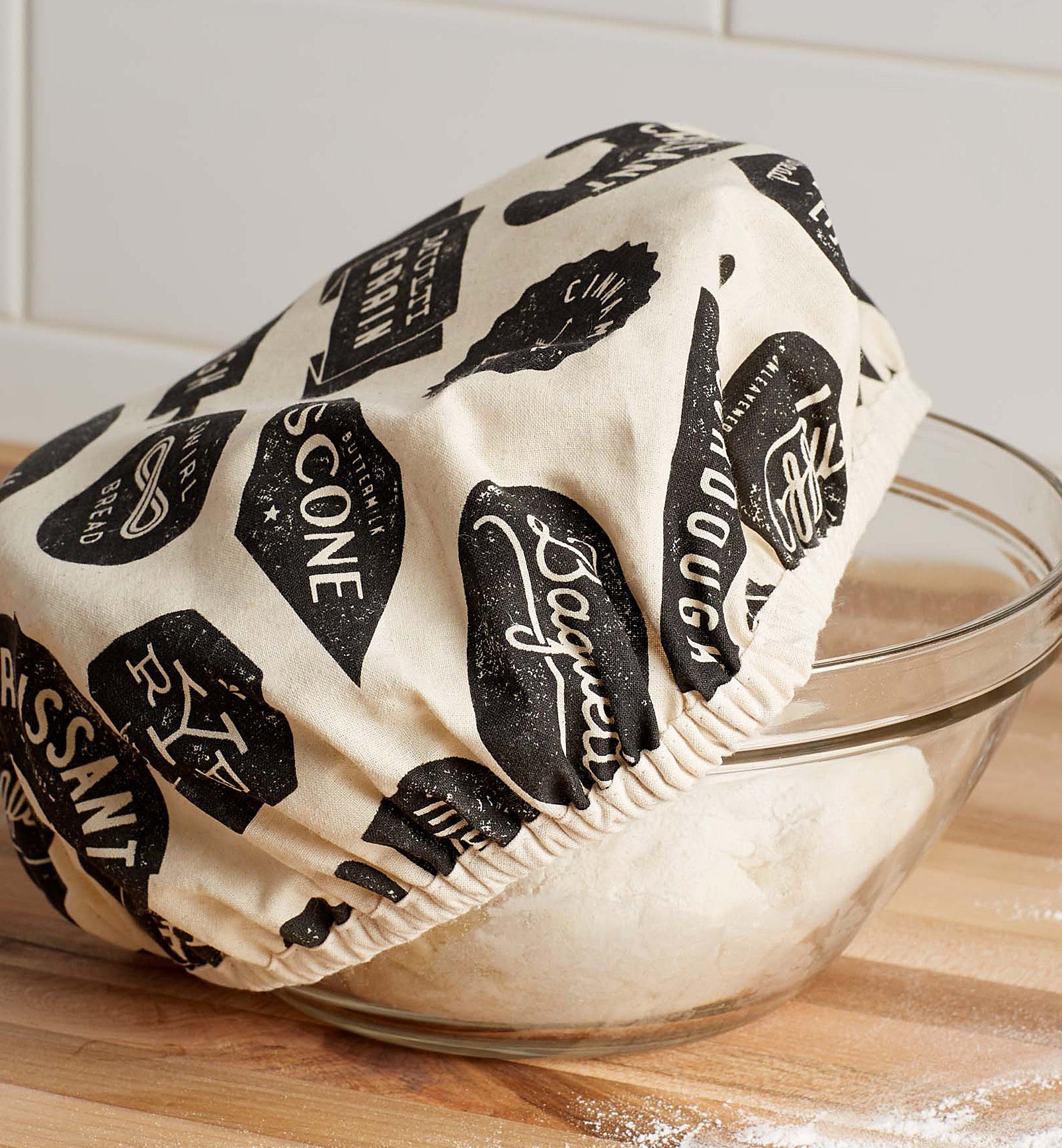 A fabric cover over a mixing bowl with dough inside