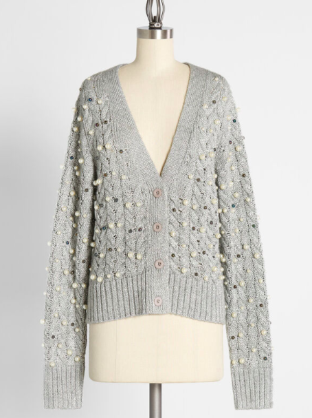 A cable knit cardigan with pearls