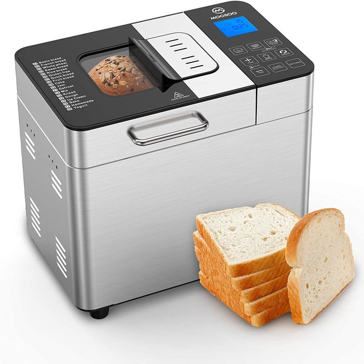 A digital bread maker displayed with bread inside of it