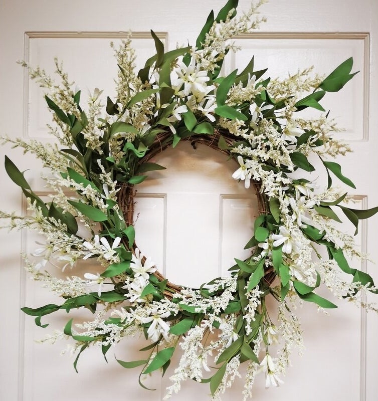 Green and white floral wreath on door 