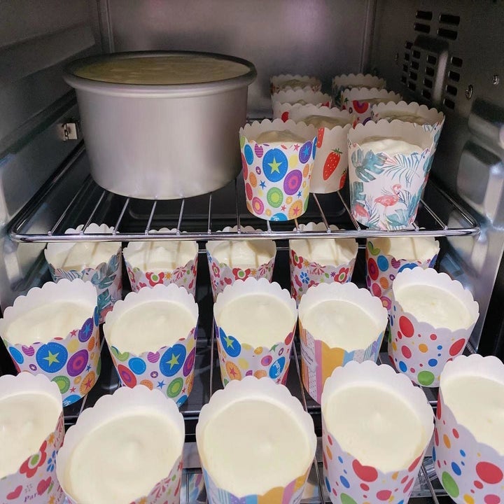 A batch of cupcakes going into an oven after being whipped with a stand mixer