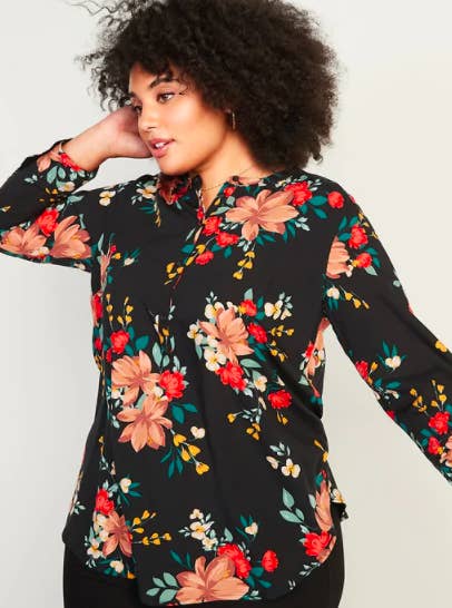 A person wearing a floral blouse