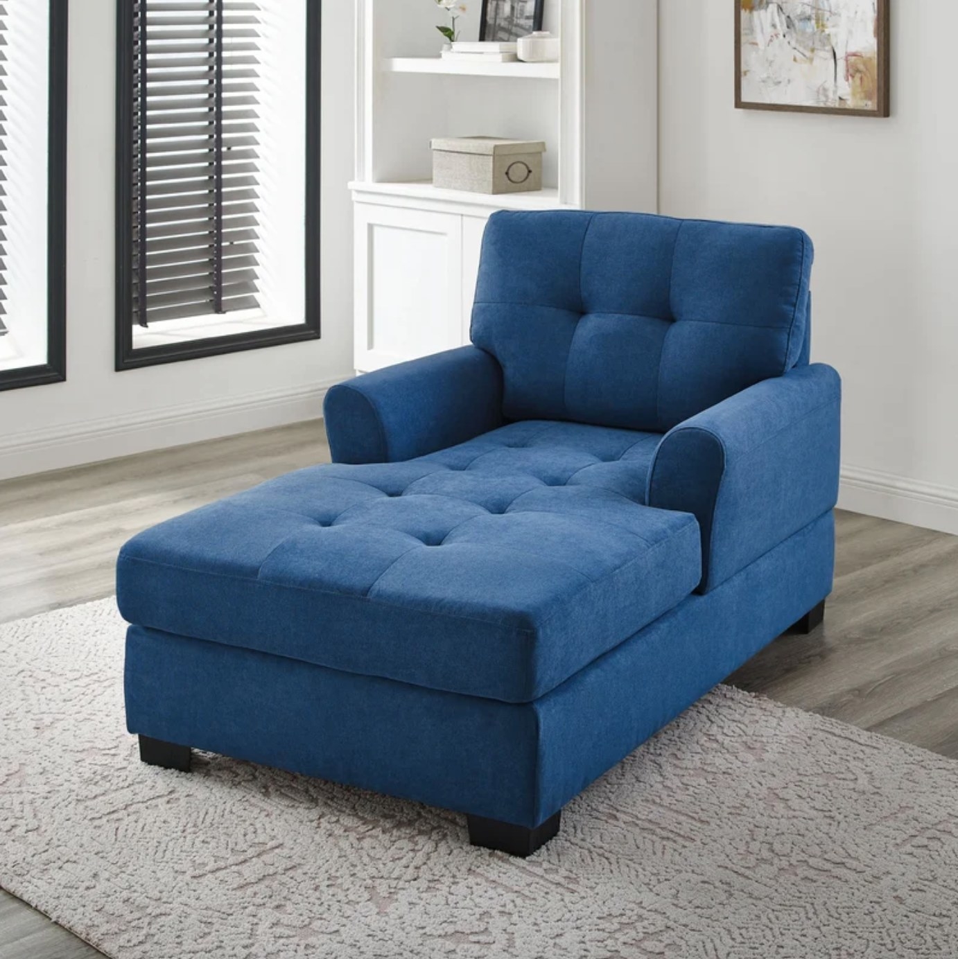 The chaise lounge in blue in a neutral-colored room