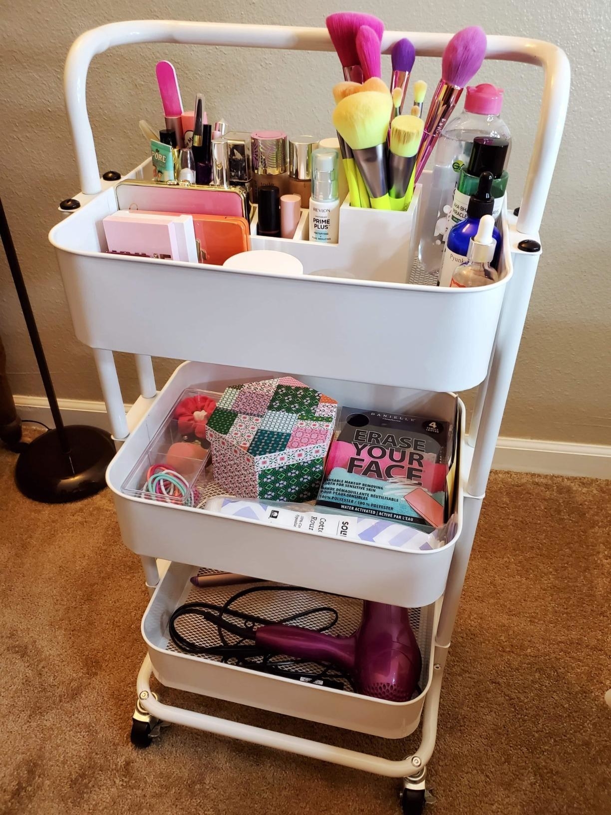 reviewer&#x27;s white cart filled with beauty products 