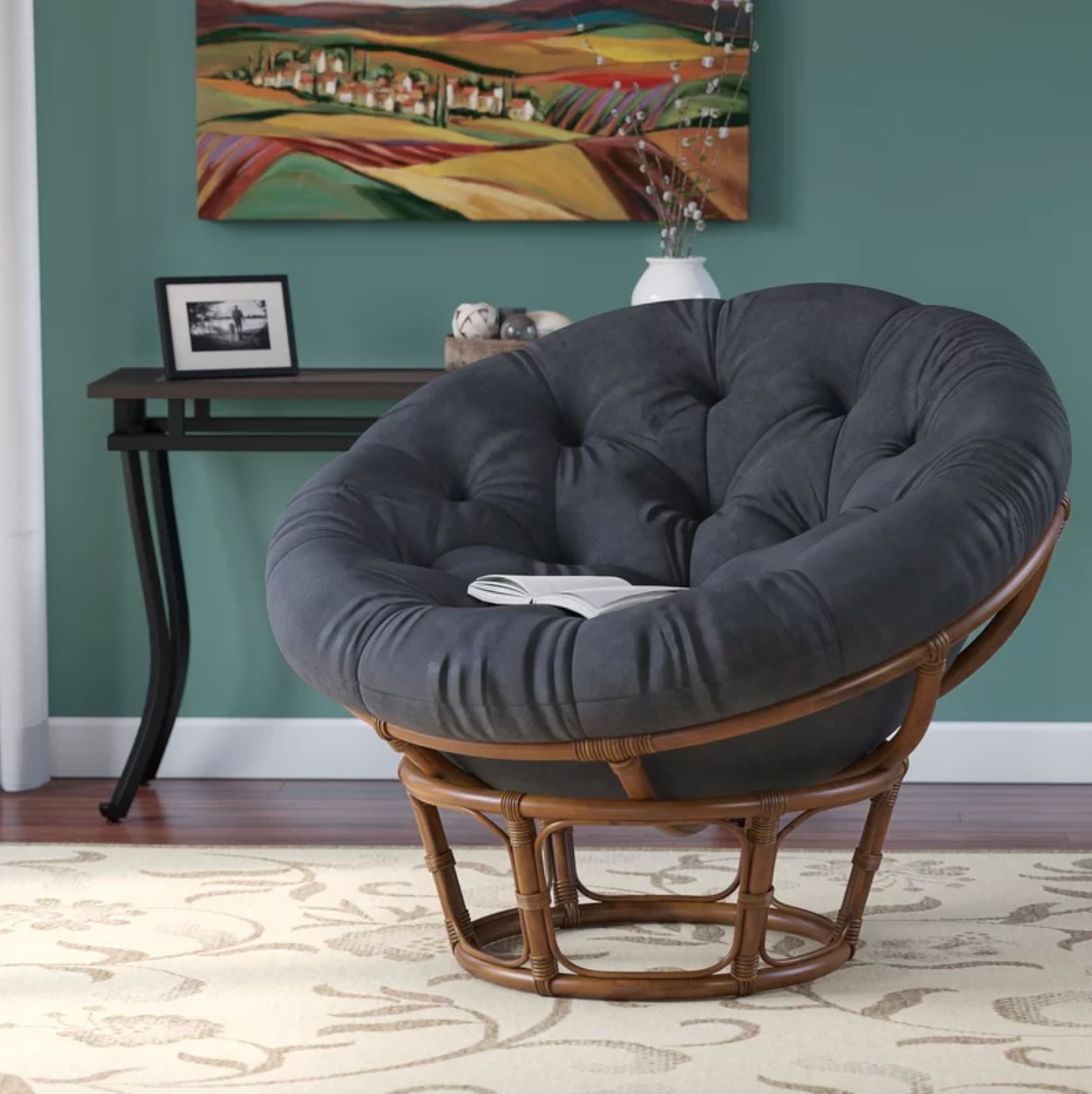 The upholstered chair with a rattan base in black microfiber