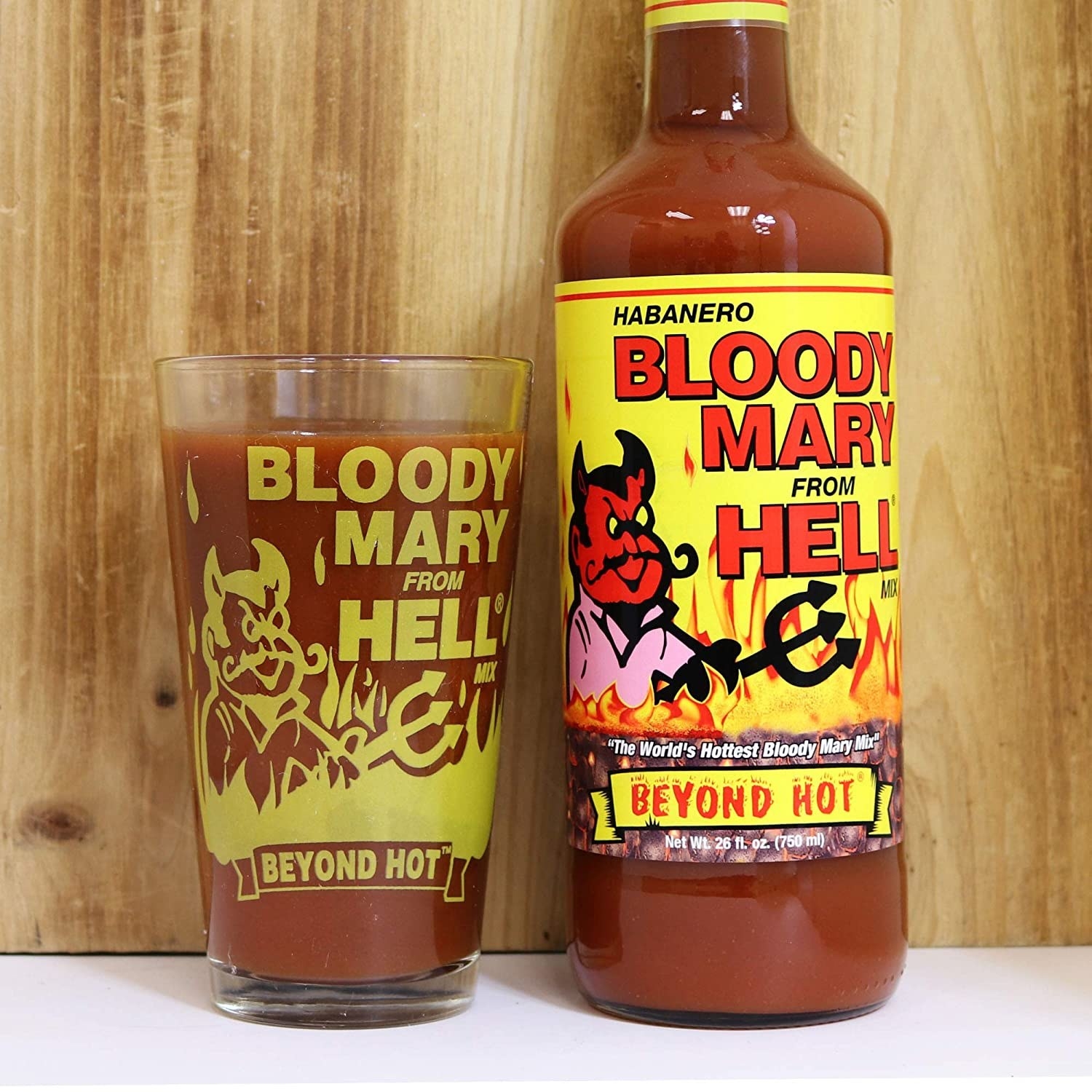 A glass and a jar with the Bloody Mary From Hell logo and liquid mix inside