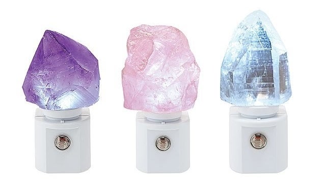 Three night-lights: one is purple amethyst, one is rose quartz, one is is clear quartz