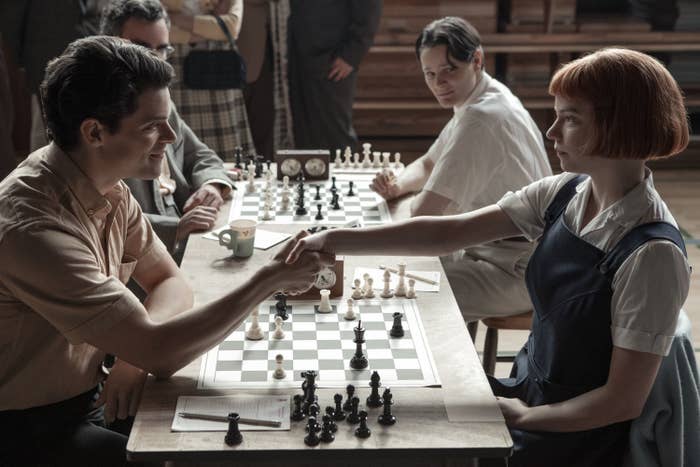 Anya Taylor-Joy as Beth shaking an opponent&#x27;s hand at a chess tournament