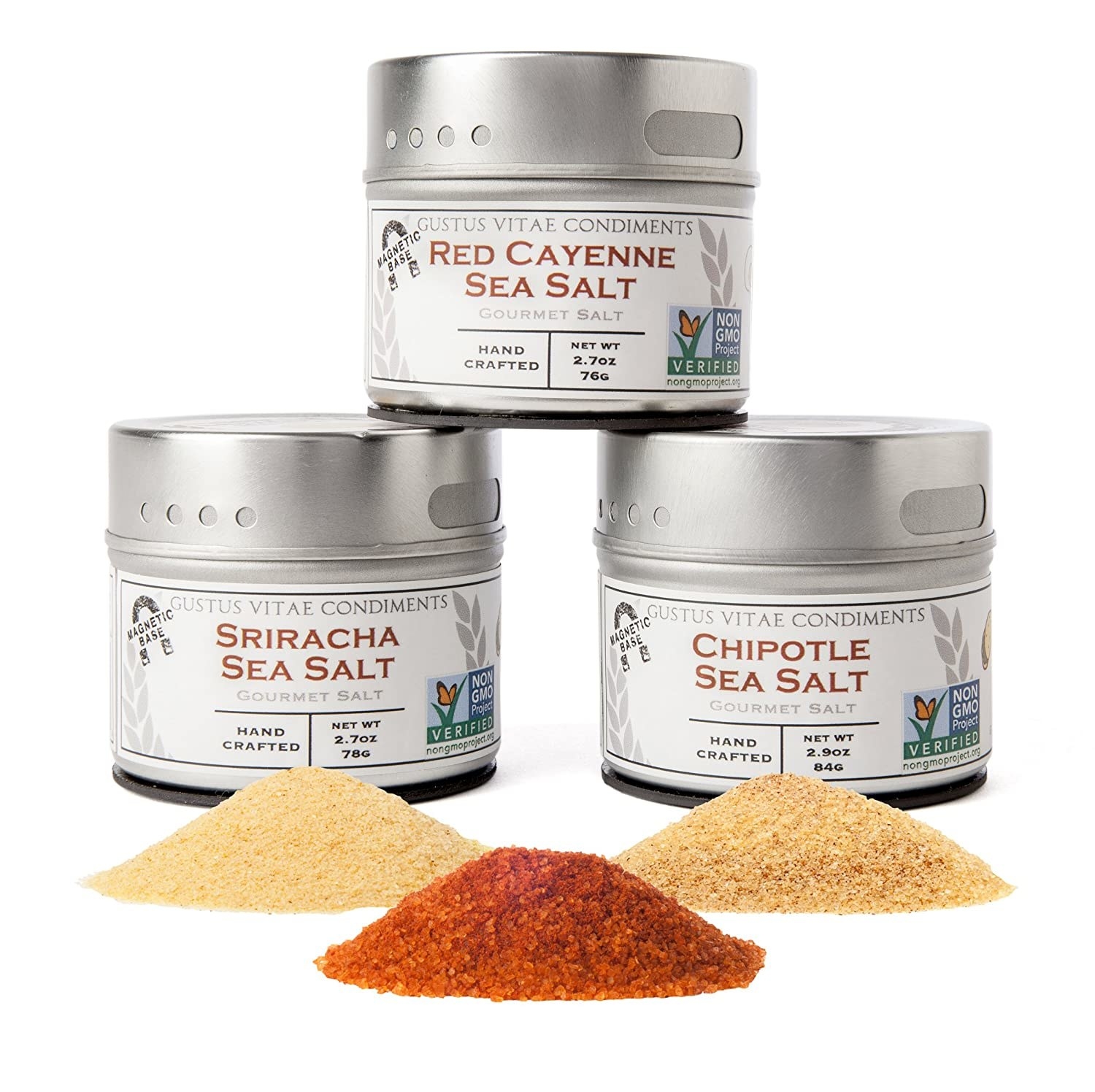 Three stacked silver tins of hot sea salts with three piles of salt