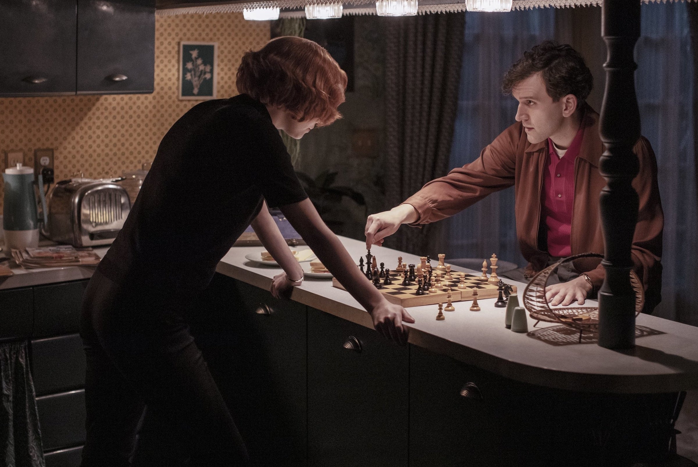 Anya and Harry playing against each other in a kitchen