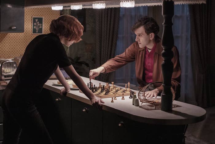 Anya and Harry playing against each other in a kitchen