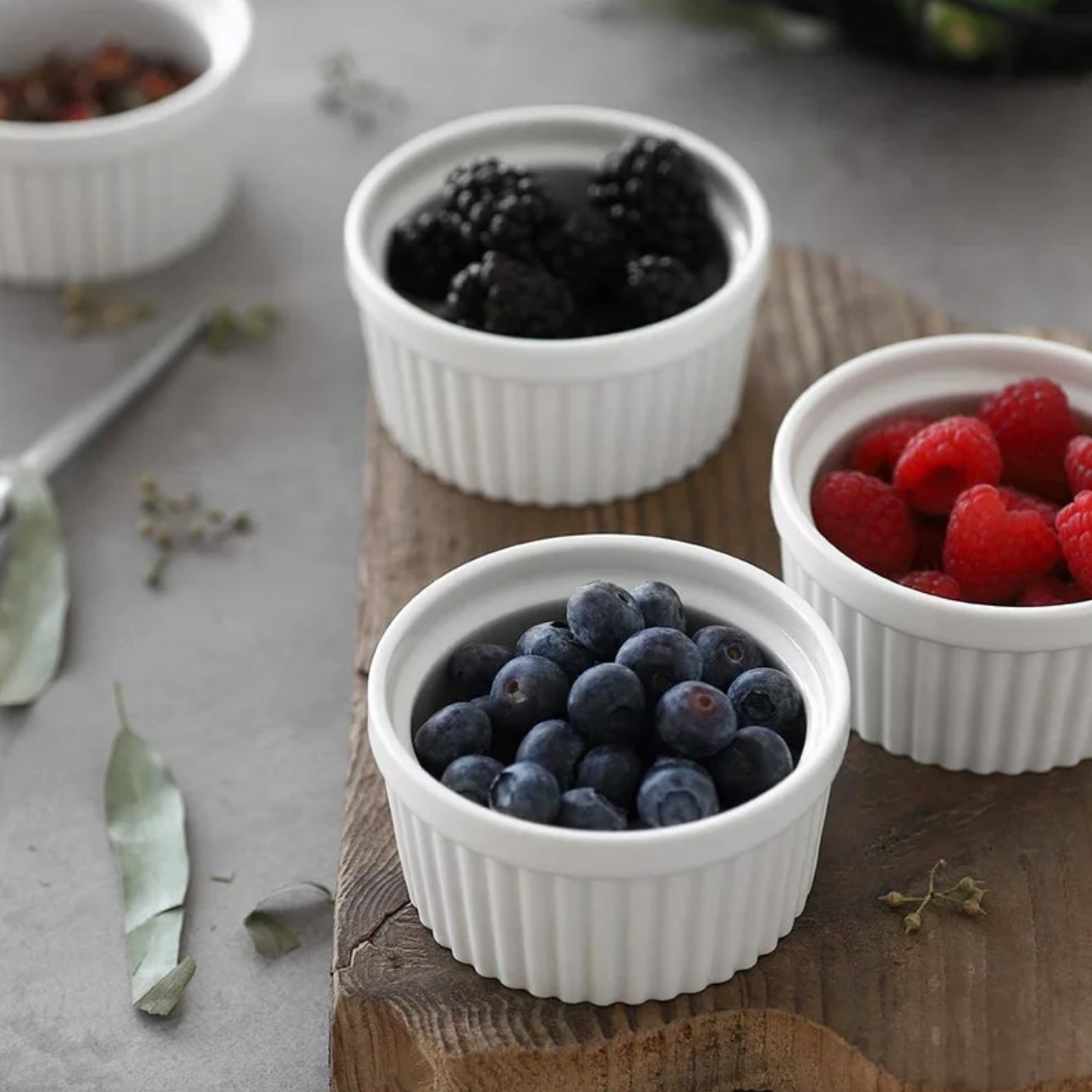 The set of six ramekins in white holding berries