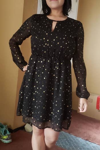 A reviewer wearing the dress, which hits above the knee, in black