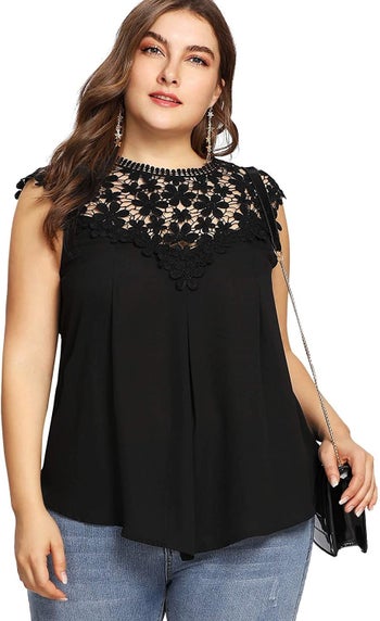 A model wearing the sleeveless top with a crochet yoke in black