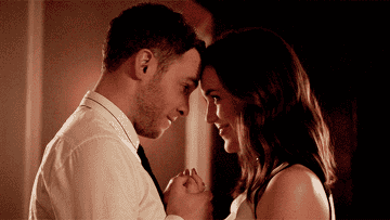 Fitz and Simmons lean their foreheads against each other as they hold hands