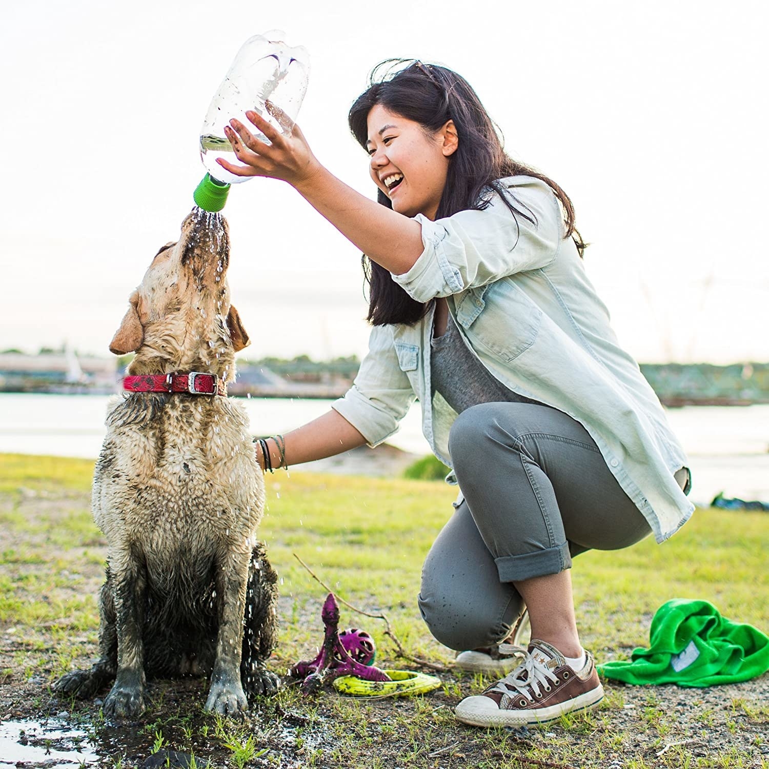 Model pours water on her dog with the green portable outdoor shower