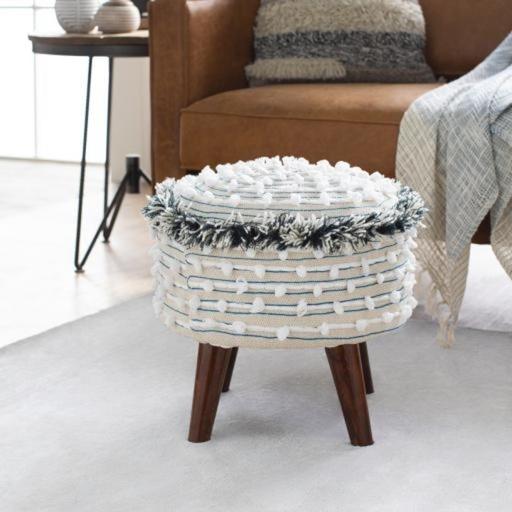 The white stool with fringe