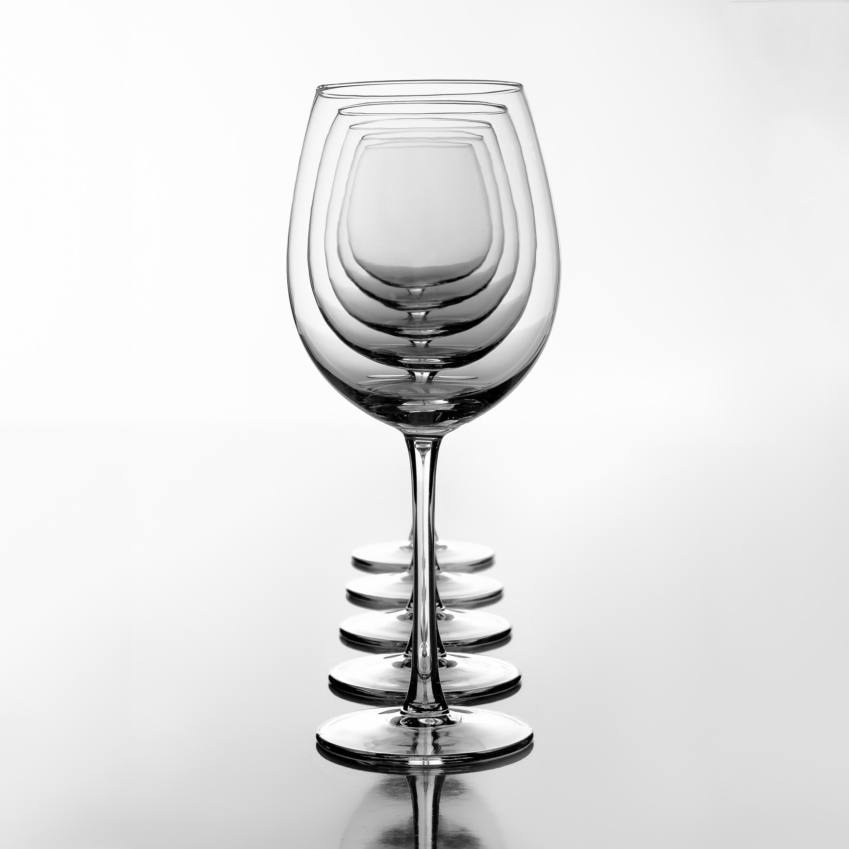 Multiple wine glasses on a white background