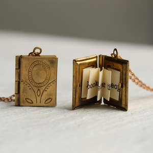 the locket open and the locket closed with the message folded inside