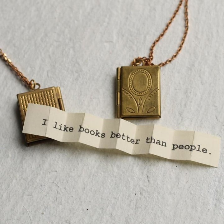 the message paper unfolded; it says "I like books better than people"