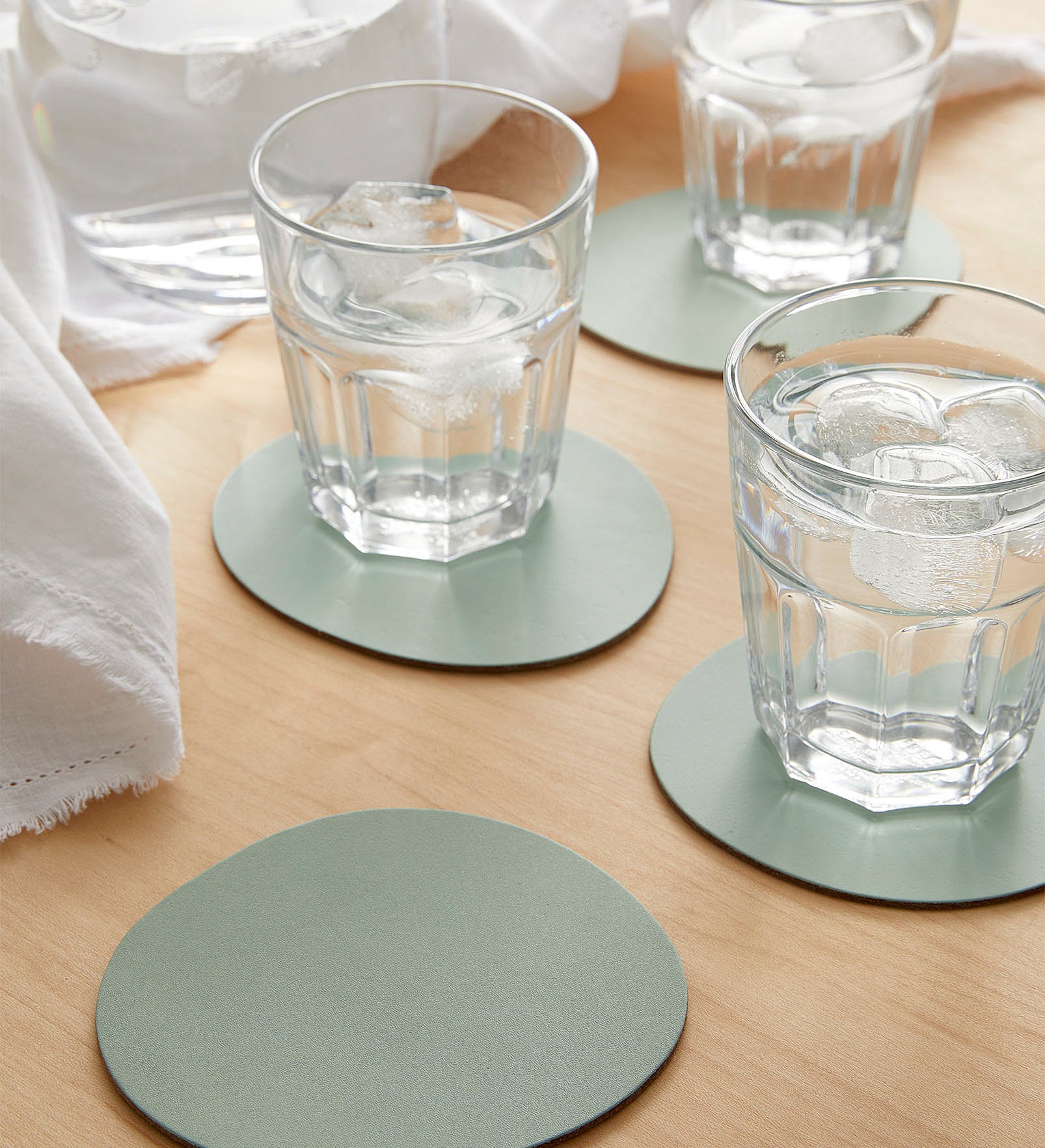 The coasters with glasses of water on them