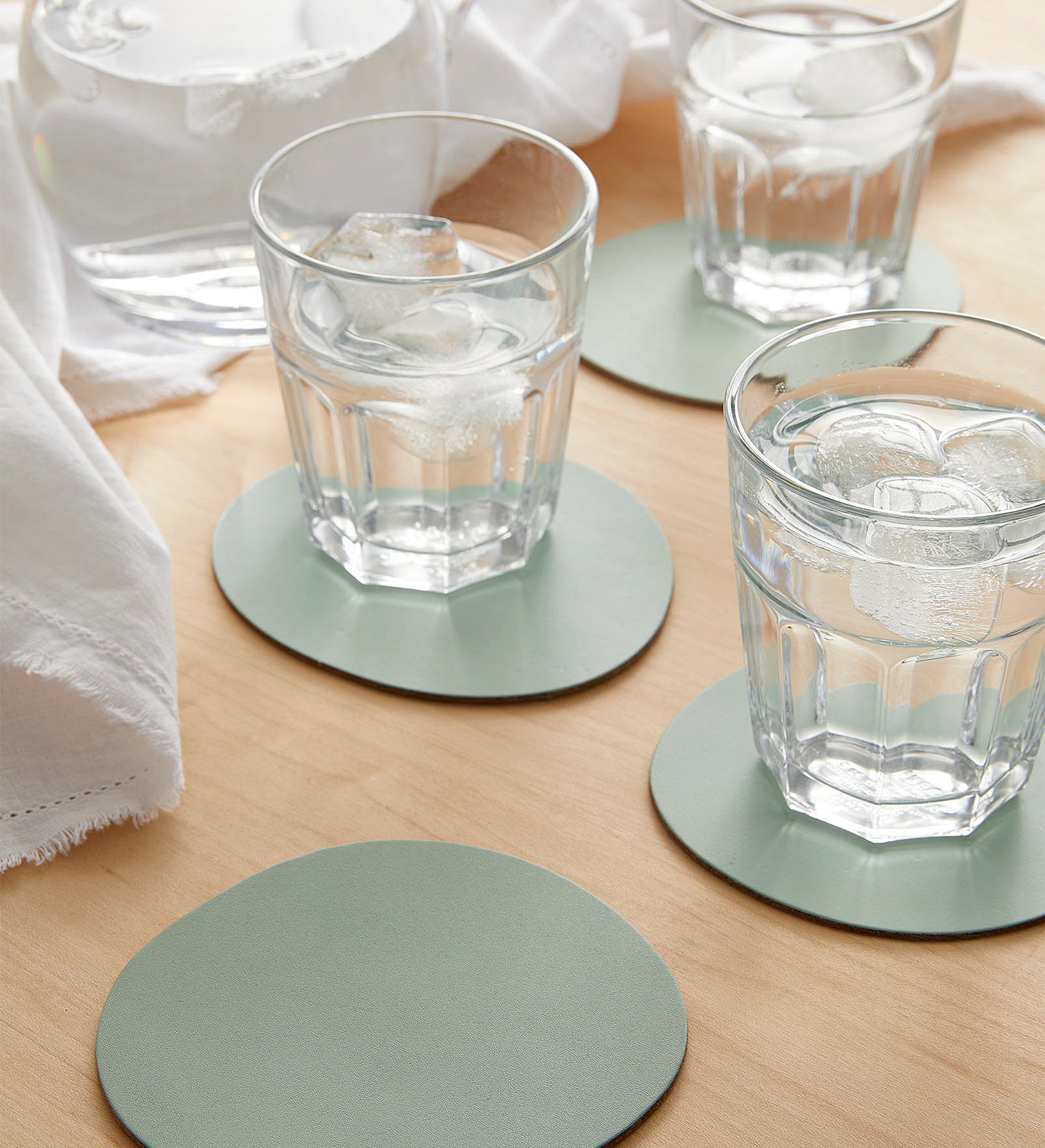 The coasters with glasses of water on them