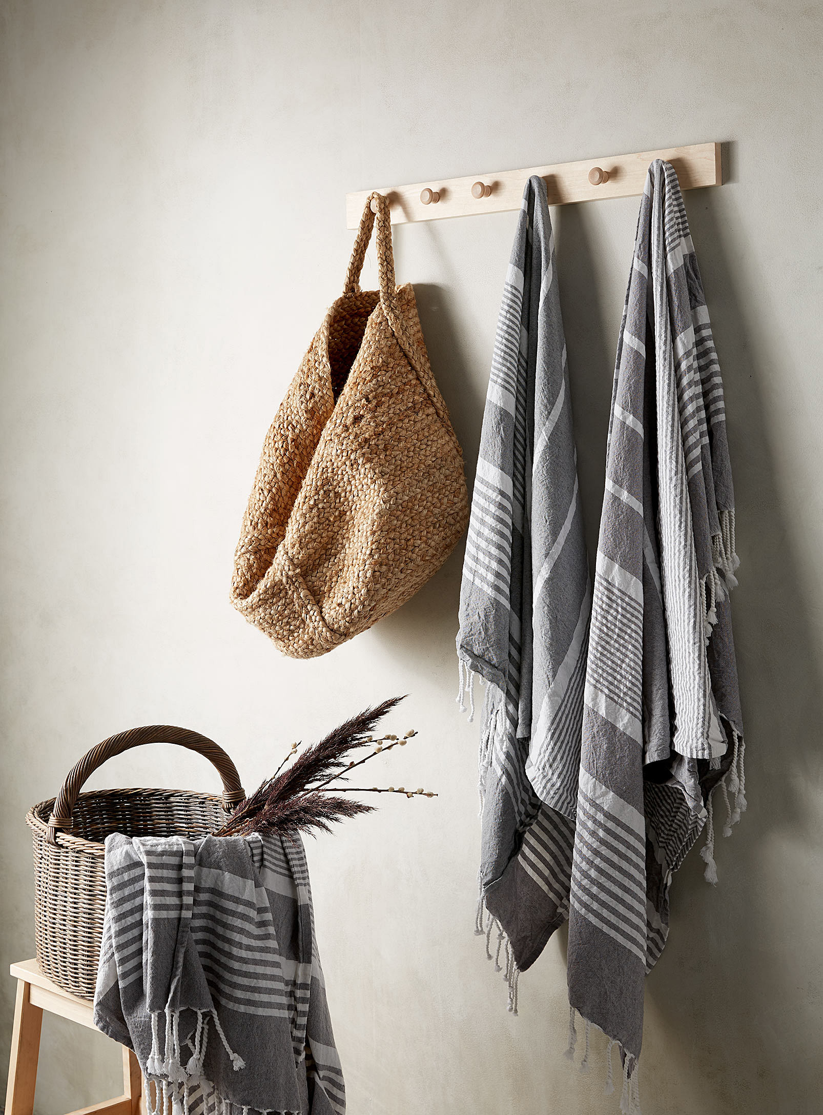 the towels hanging from a hook and out of a basket