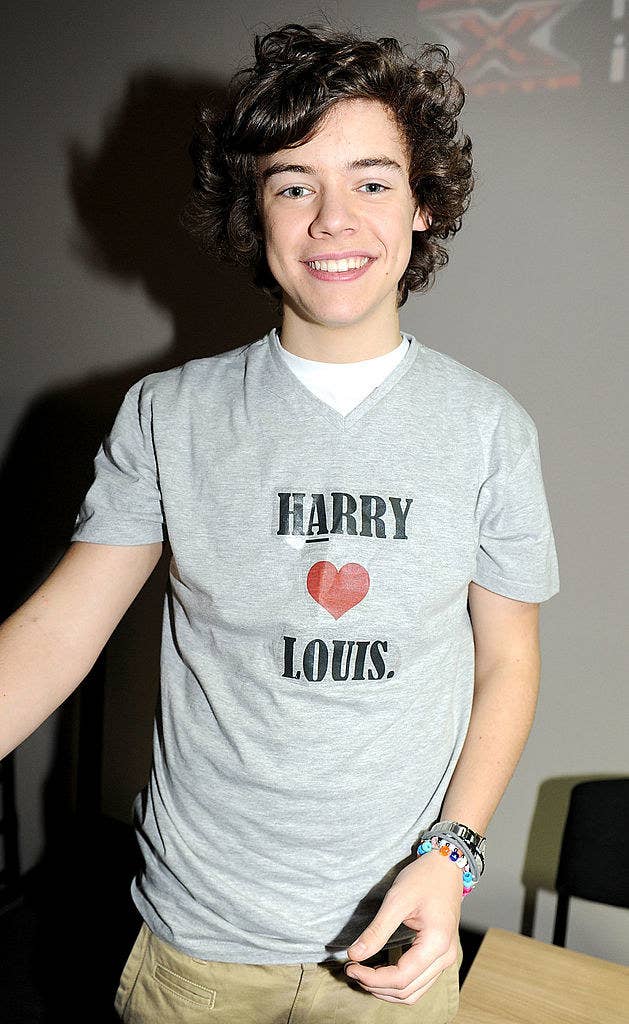 Harry Styles at a One Direction book signing while wearing a &quot;Harry Hearts Louis&quot; t-shirt