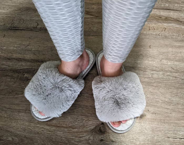 Reviewer wearing the fuzzy slipper slide with open toes