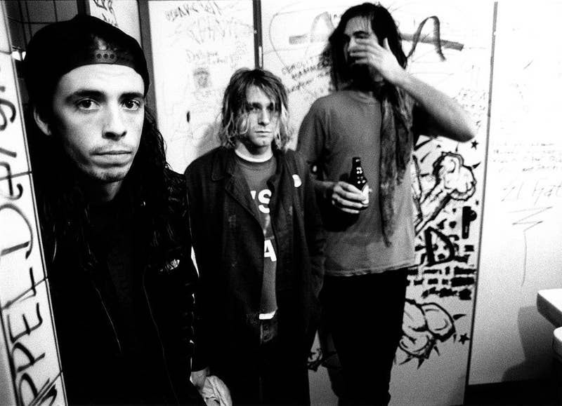 Nirvana posing for a group shot in a bathroom in 1991