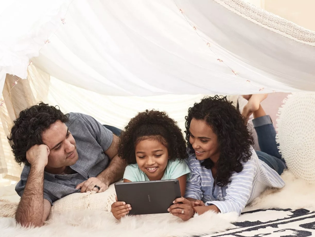 A family looking at a tablet