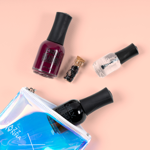 the small vial of crystals, two polishes, and a bottle of nail treatment 