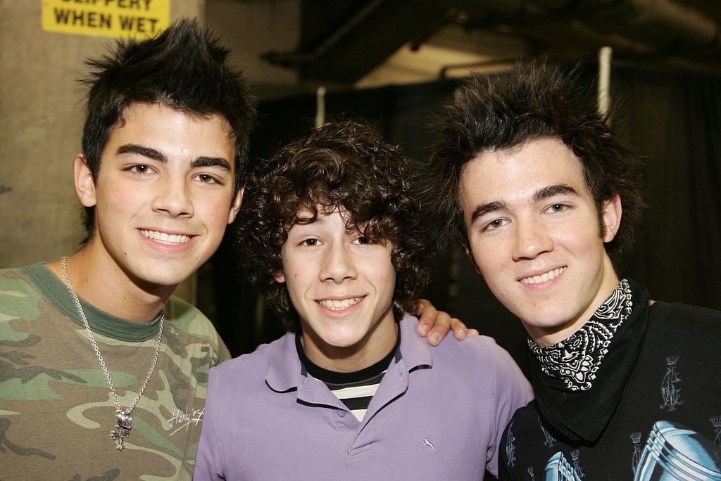 The Jonas Brothers posing backstage as a Radio Disney event in 2006