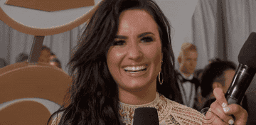 GIF of Demi smiling while being interviewed