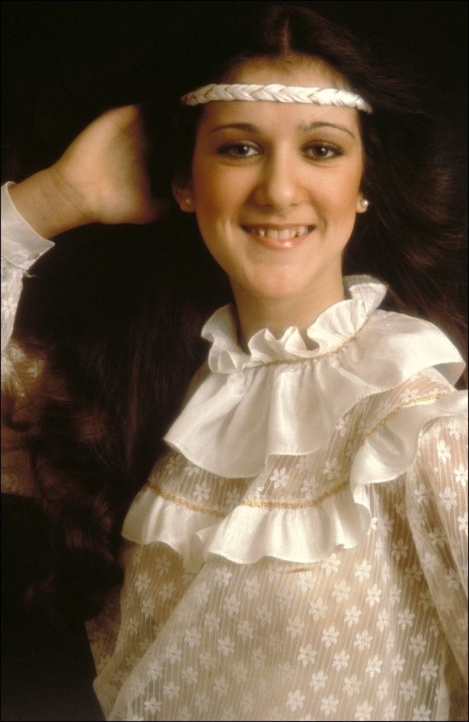 Celine Dion posing for a portrait in the 1980s, wearing a headband and long, brown hair