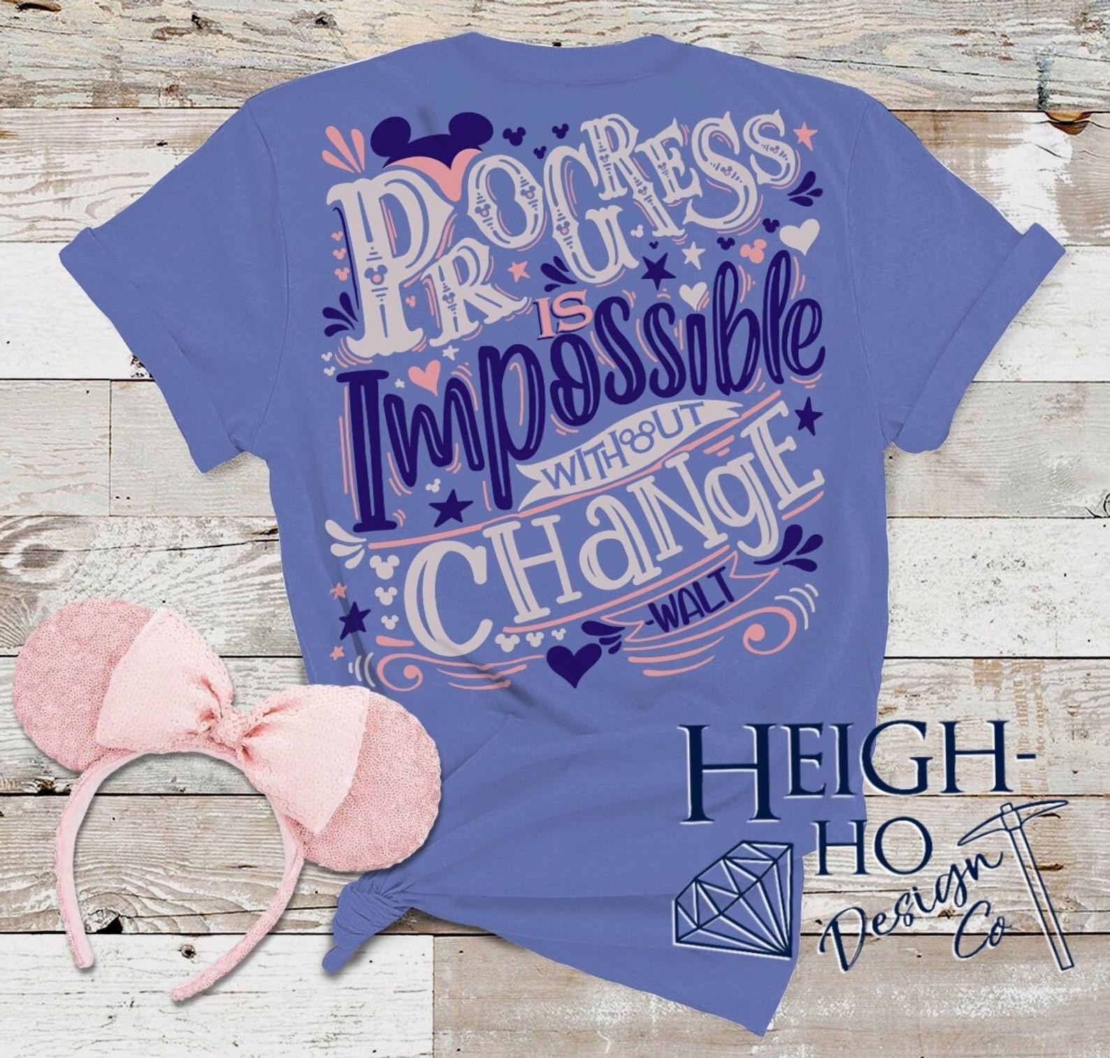 the back of a purple tee with the words &quot;progress is impossible without change&quot; artfulyl drawn