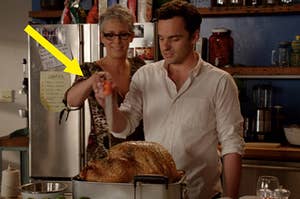 Nick and Jess's mom basting a turkey together