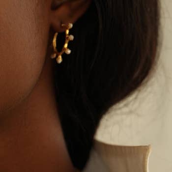 A person wearing the hoop earrings