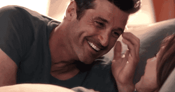 Derek and Meredith laughing in bed together 