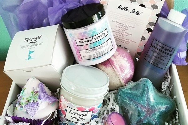 the box with Mermaid themed bath bombs. whipped body butter, and shimmering bath gel inside 