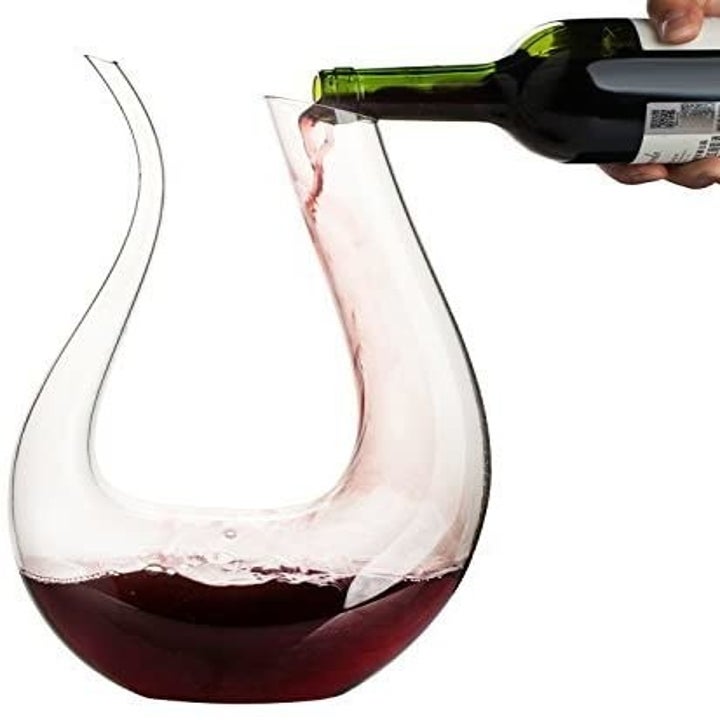 U-shape wine decanter with red wine in it 