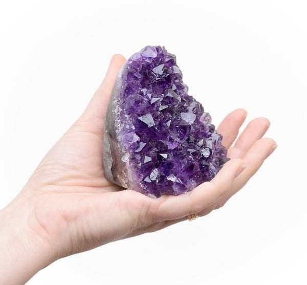 A person holding the geode