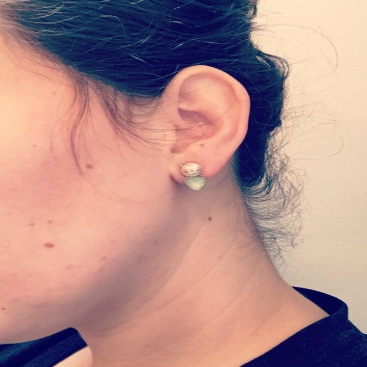 A reviewer wearing the studs