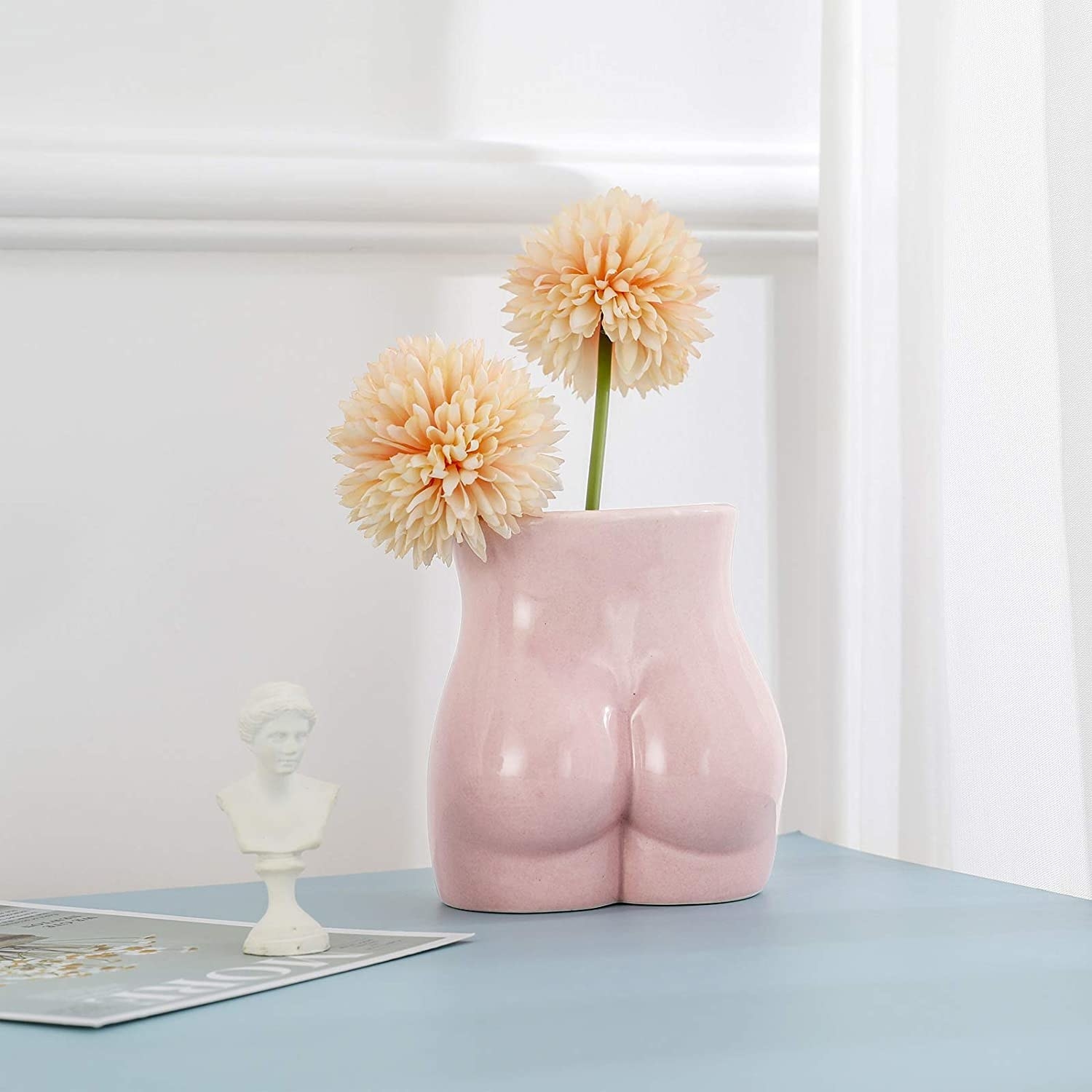 pink butt-shaped vase on a tabletop
