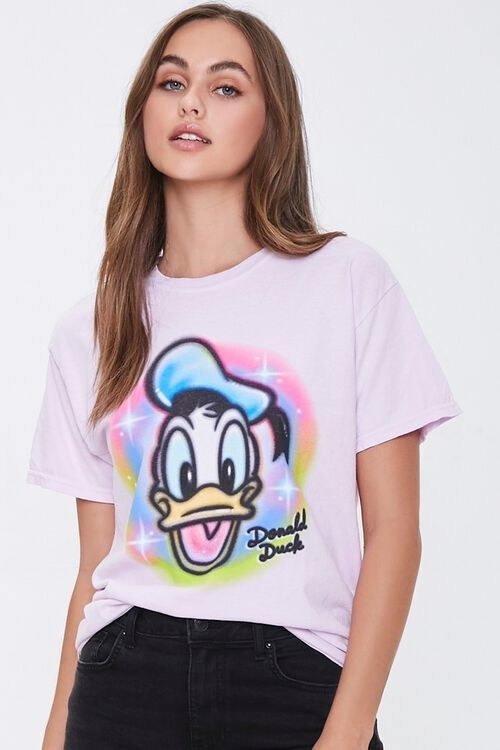 a model in a lavender tee with donald duck on it