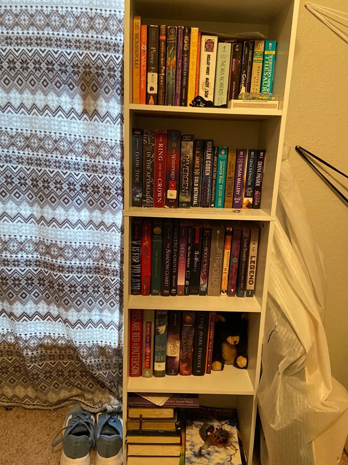 reviewer&#x27;s five-shelf white bookcase filled with books 